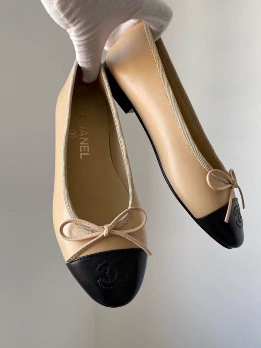 CHANEL Beige Black Cap‑Toe CC Ballet Flats
